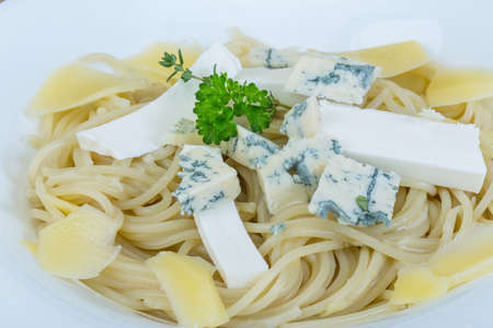 Pasta with various cheese and parsley branchの写真素材