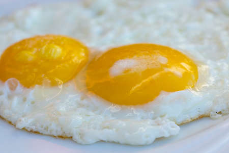 Fried two eggs in the white bowlの写真素材