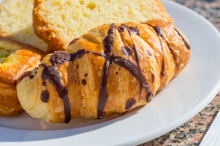 Croissant with chocolate in the white bowlの写真素材