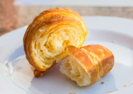 Fresh baked Croissant in the white bowlの写真素材