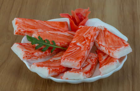 Crab sticks with ruccola leaf on the woodの写真素材