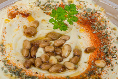 Hummus in the bowl with paprica and cedar nutの写真素材