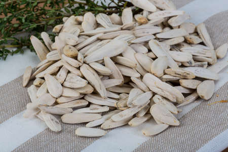 White sunflower seeds in the bowl on napkin