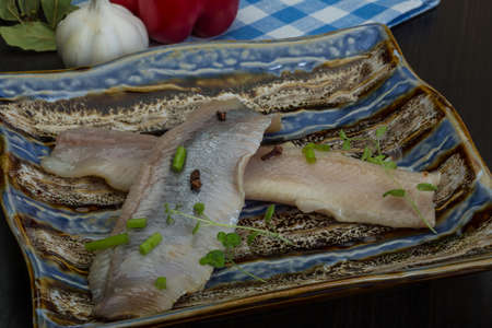 Herring fillet with herbs and spyces in the bowlの写真素材