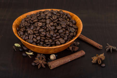 Roasted coffee beans in the bowl with cinamonの写真素材