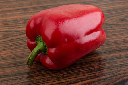 Fresh vivid Red bulgarian pepper on the wood backgroundの写真素材