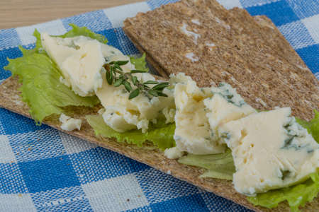 Crispbread with soft blue cheese and saladの写真素材