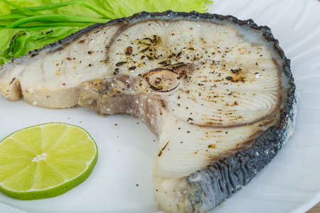 Grilled shark stesk with lime and salad leaves