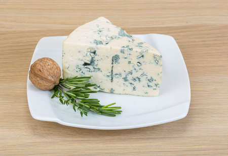 Blue cheese with mold on the wood backgroundの写真素材