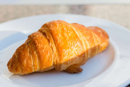 Fresh baked Croissant in the white bowlの写真素材