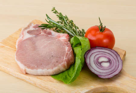 Raw pork steak with thyme and rosemaryの写真素材