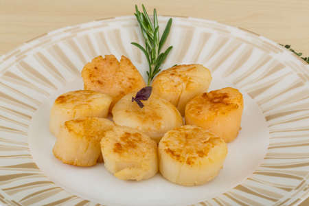 Grilled scallops in the bowl with herbsの写真素材