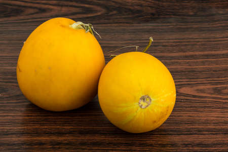 Small yellow melon on the wooden backgroundの写真素材