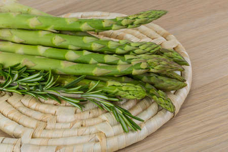 Raw asparagus heap on the wood backgroundの写真素材