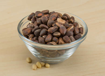 Brown Cedar nut on the wood backgroundの写真素材