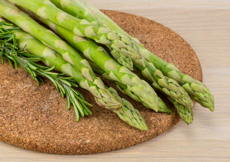 Raw asparagus heap on the wood backgroundの写真素材