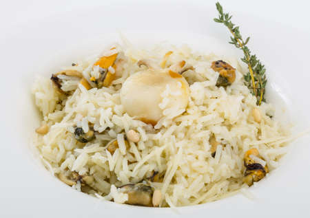 Risotto with mussels and cuttlefish served fresh thymeの写真素材