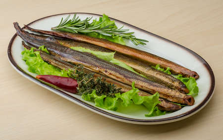 Smoked Lamprey - seafood delicacy with salad and herbs