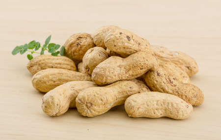 Raw peanuts heap on the wood backgroundの写真素材