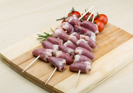 Raw chicken hearts ready for barbecue with rosemaryの写真素材