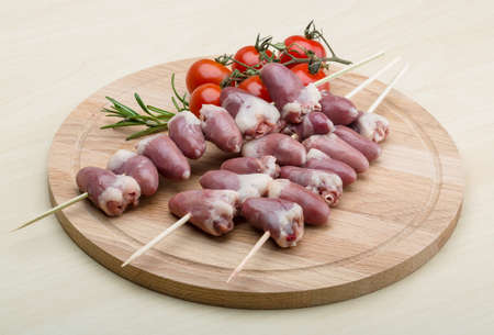 Raw chicken hearts ready for barbecue with rosemaryの写真素材