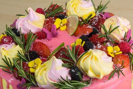 Cake with meringue and strawberries, lime, rosemary