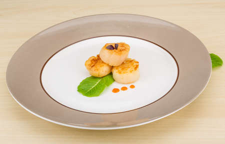 Grilled scallops in the bowl with herbsの写真素材