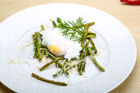 Benedict egg with grilled asparagus and parmesanの写真素材