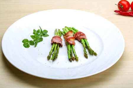 Grilled asparagus with bacon, basil and sesameの写真素材