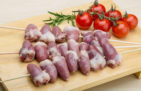 Raw chicken hearts ready for barbecue with rosemaryの写真素材