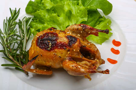 Roasted Quail with rosemary and spices on the wood の写真素材