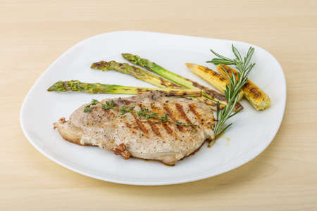 Pork steak with grilled asparagus and baby cornの写真素材