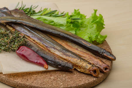 Smoked Lamprey - seafood delicacy with salad and herbs