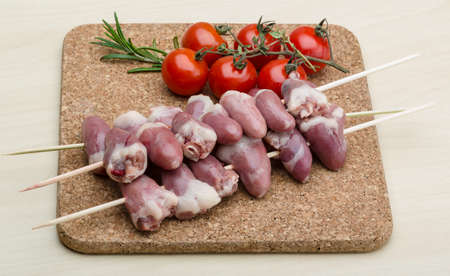 Raw chicken hearts ready for barbecue with rosemaryの写真素材