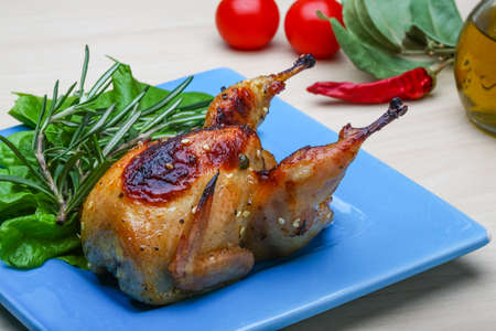 Roasted Quail with rosemary and spices on the wood の写真素材