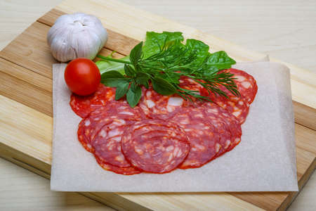 Chorizo sausage - spanish salami on the wood backgroundの写真素材