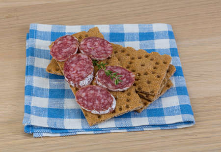 Crispbread with salami and fresh rucola leavesの写真素材