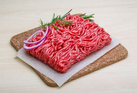 Raw beef minced meat with rosemary and onion