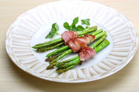 Grilled asparagus with bacon, basil and sesameの写真素材