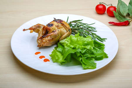 Roasted Quail with rosemary and spices on the wood backgroundの写真素材
