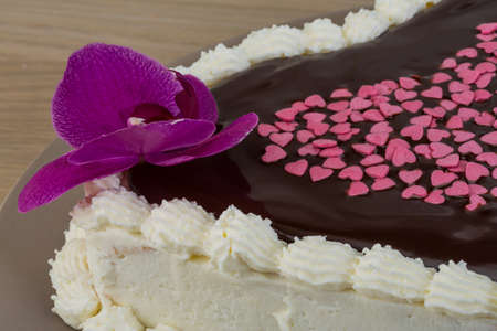 Valentine Chocolate icing cake with flower and heartsの写真素材