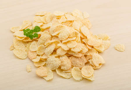 Cornflakes heap on the wood background