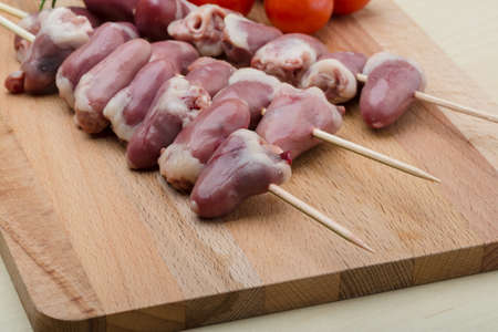 Raw chicken hearts ready for barbecue with rosemaryの写真素材