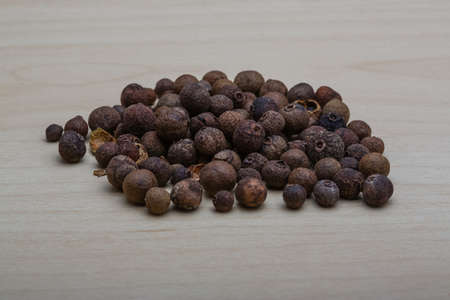 Pepper corn heap on the wood backgroundの写真素材