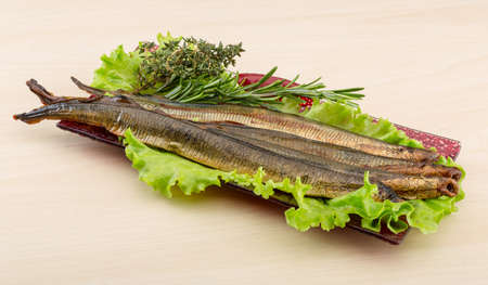 Smoked Lamprey - seafood delicacy with salad and herbsの写真素材