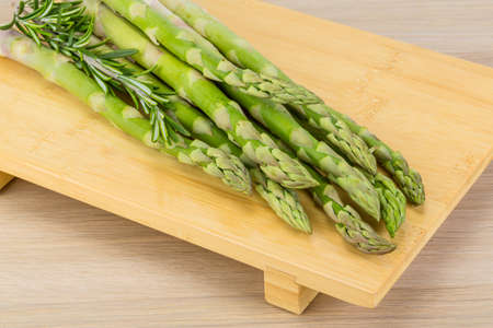Raw asparagus heap on the wood backgroundの写真素材