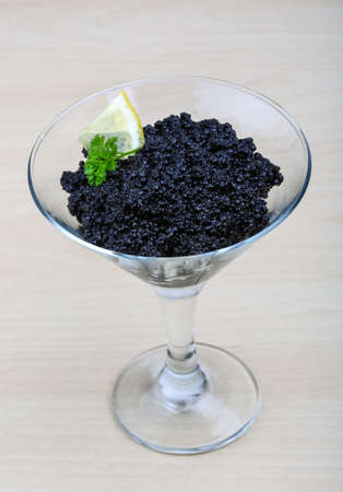 Luxury Black caviar with parsley and lemonの写真素材