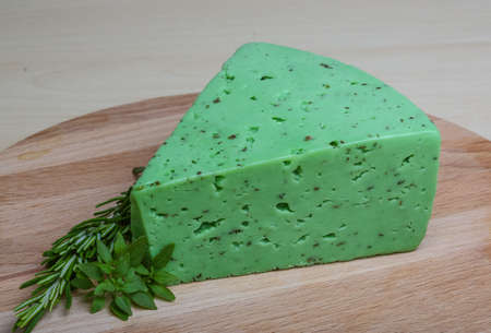 Green pesto cheese with rosemary basil leavesの写真素材