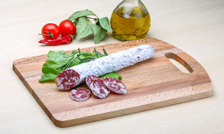 Spanish sausage - fuet salami with rosemary and salad