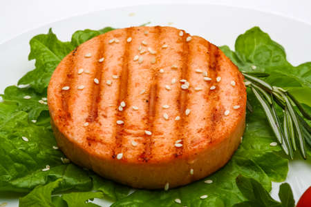 Salmon burger cutlet with sesame seeds and saladの写真素材